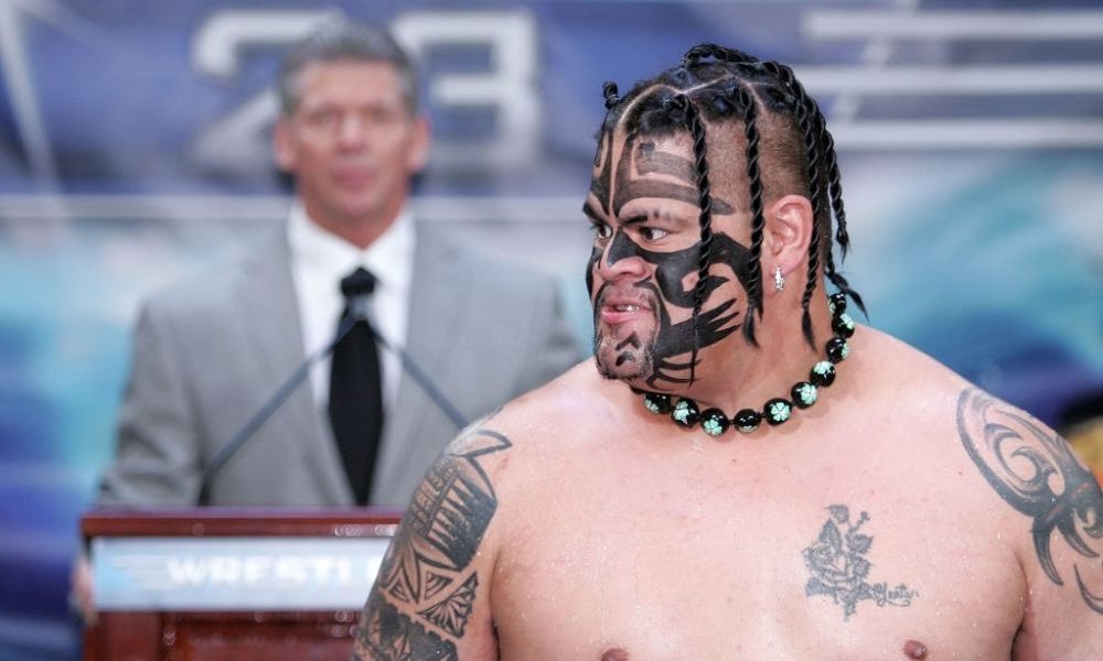 Umaga with Vince McMahon in the background.