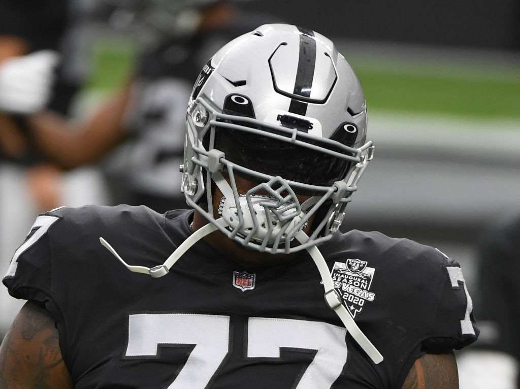 Offensive tackle Trent Brown #77 of the Las Vegas Raiders wears a helmet featuring a raised fist design on the face mask as he warms up before a game against the Indianapolis Colts at Allegiant Stadium on December 13, 2020 in Las Vegas, Nevada. The Colts defeated the Raiders 44-27.