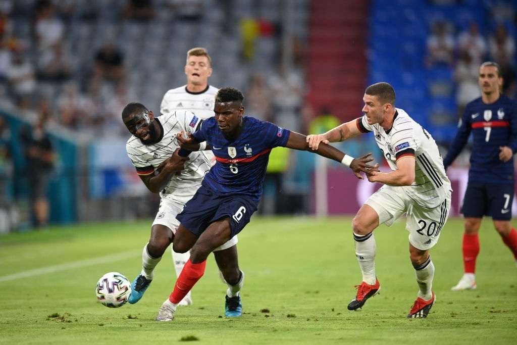 Paul Pogba of France battles for possession with Antonio Ruediger and Robin Gosens of Germany during the UEFA Euro 2020