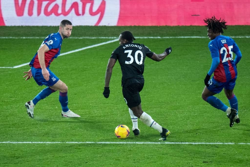 Michail Antonio of West Ham United and Gary Cahill and Eberechi Eze of Crystal Palace