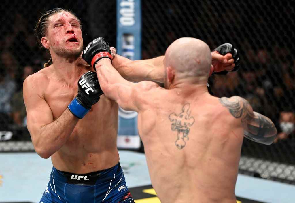 Alexander Volkanovski of Australia punches Brian Ortega in their UFC featherweight championship fight during the UFC 266 event on September 25, 2021 in Las Vegas, Nevada.