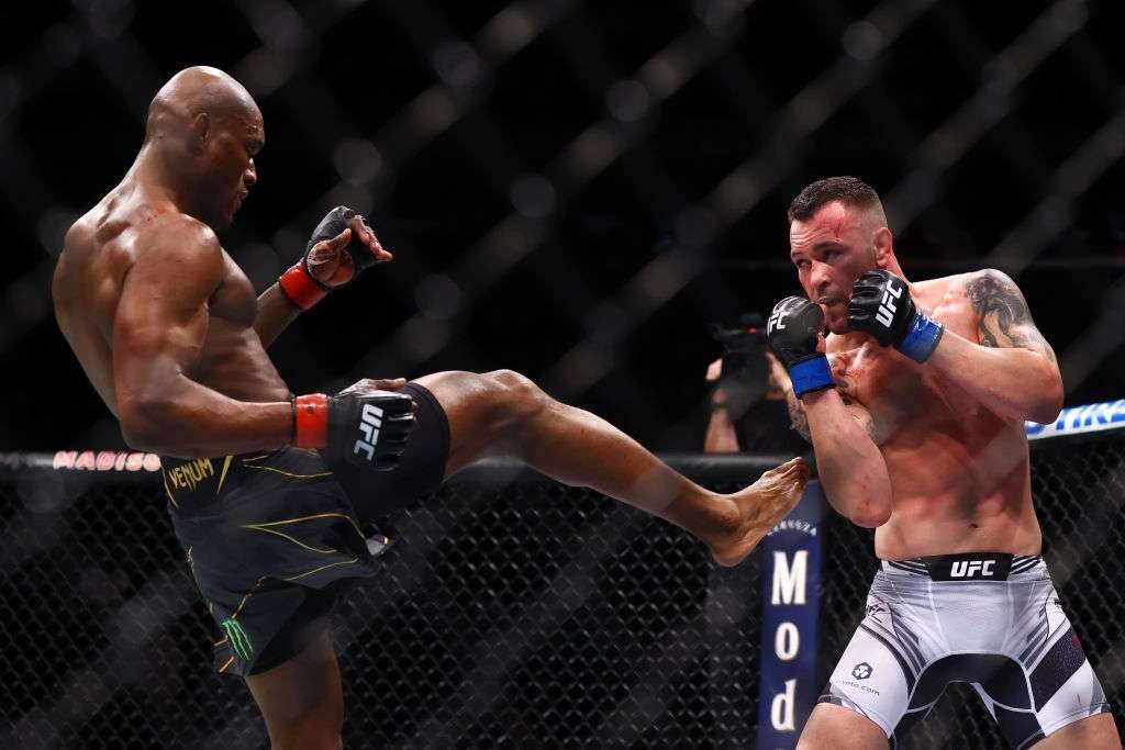 Kamaru Usman celebrates kicks Colby Covington in their welterweight title bout during the UFC 268 event at Madison Square Garden on November 06, 2021 in New York City. (Credits: Getty Images)