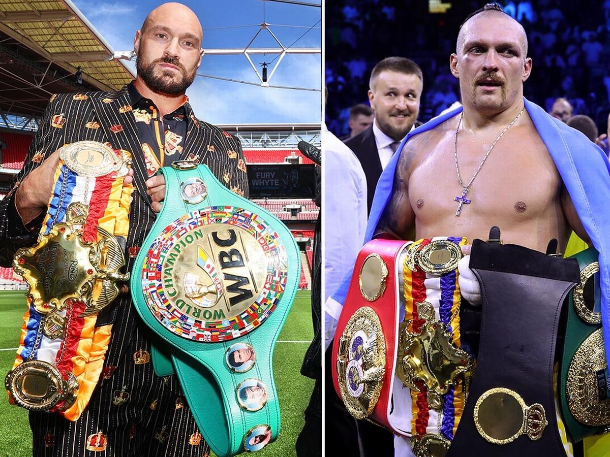 Tyson Fury posing with his titles