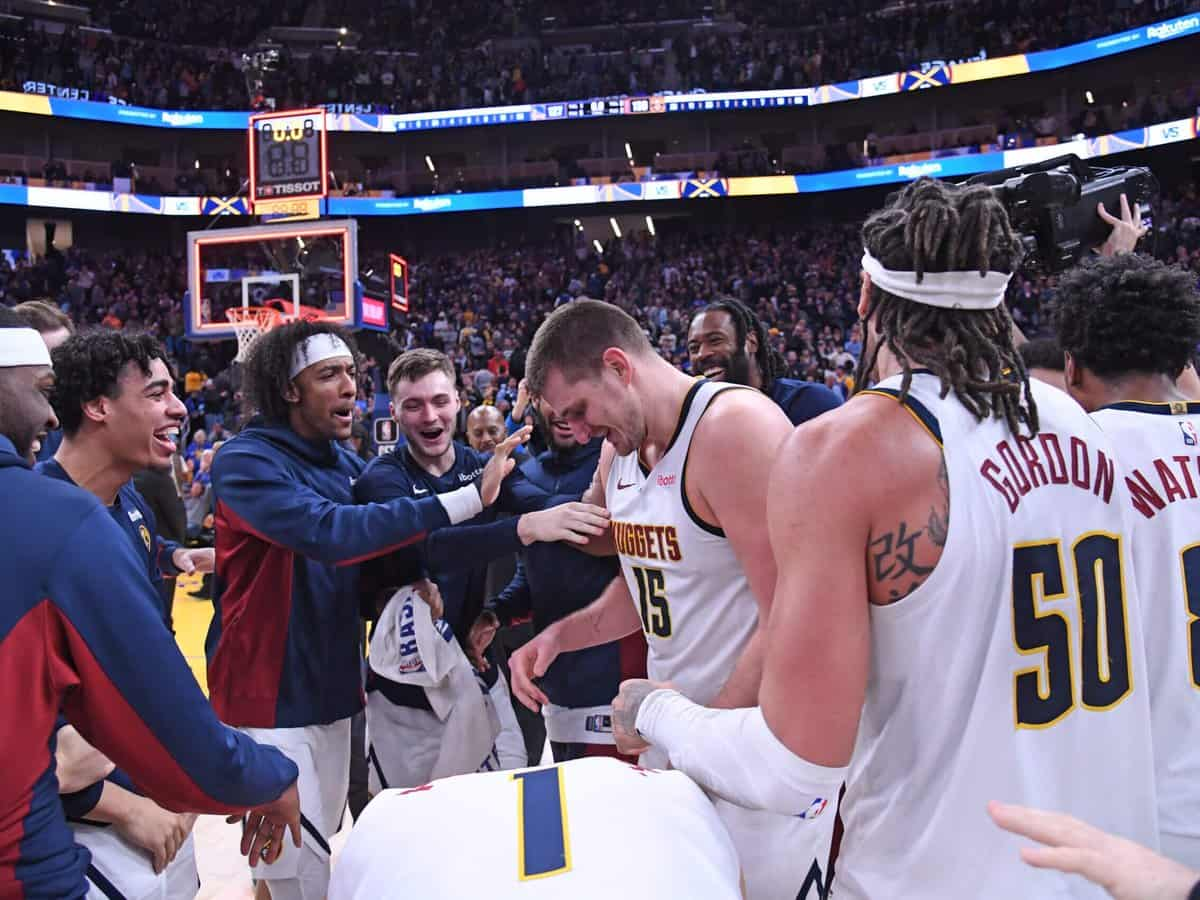 Nikola Jokic makes the 40-foot long bank shot.